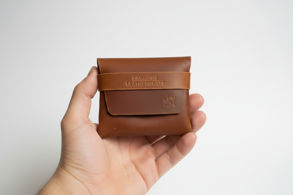 Origami Card Holder Wallet by zazone — red brown matte leather held in hand, showing natural grain texture and tan strap band