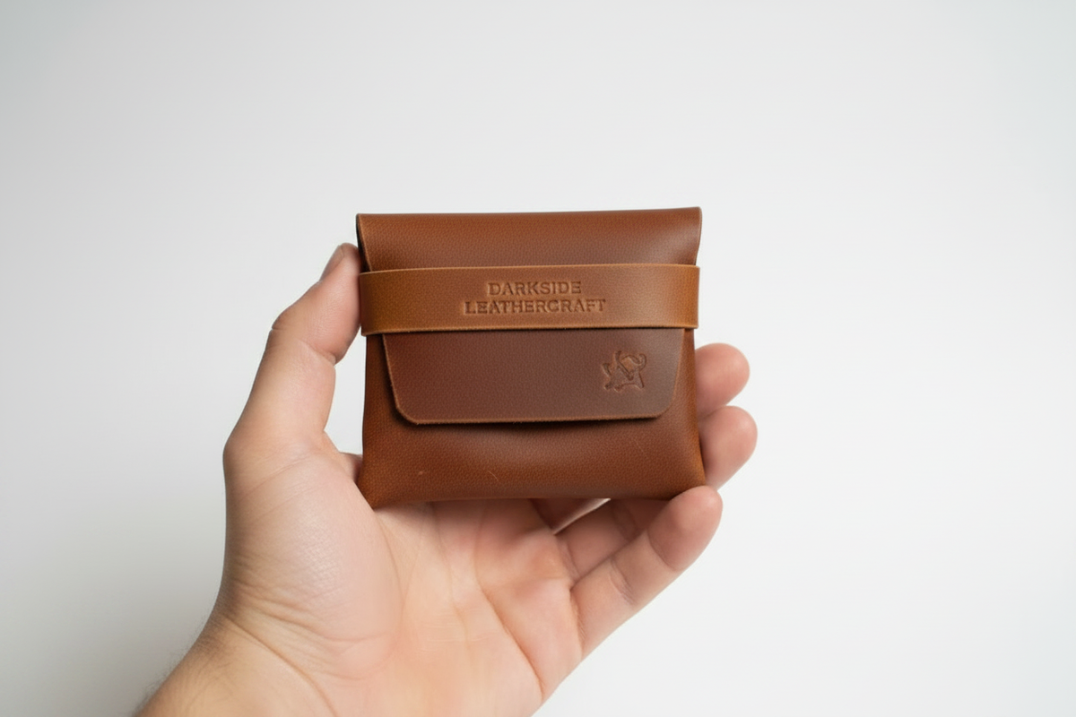 Origami Card Holder Wallet by zazone — red brown matte leather held in hand, showing natural grain texture and tan strap band