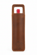 Leather wine holder single - with wine bottle inside showing embossed protea design on white background